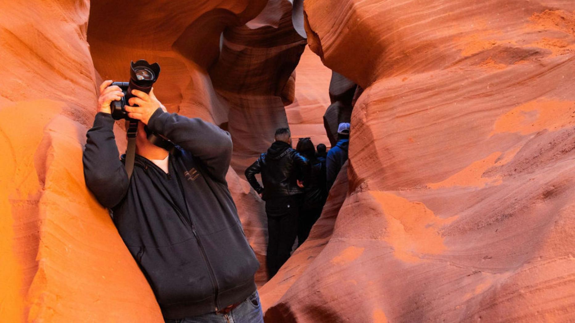 man taking photos in antelope canyon