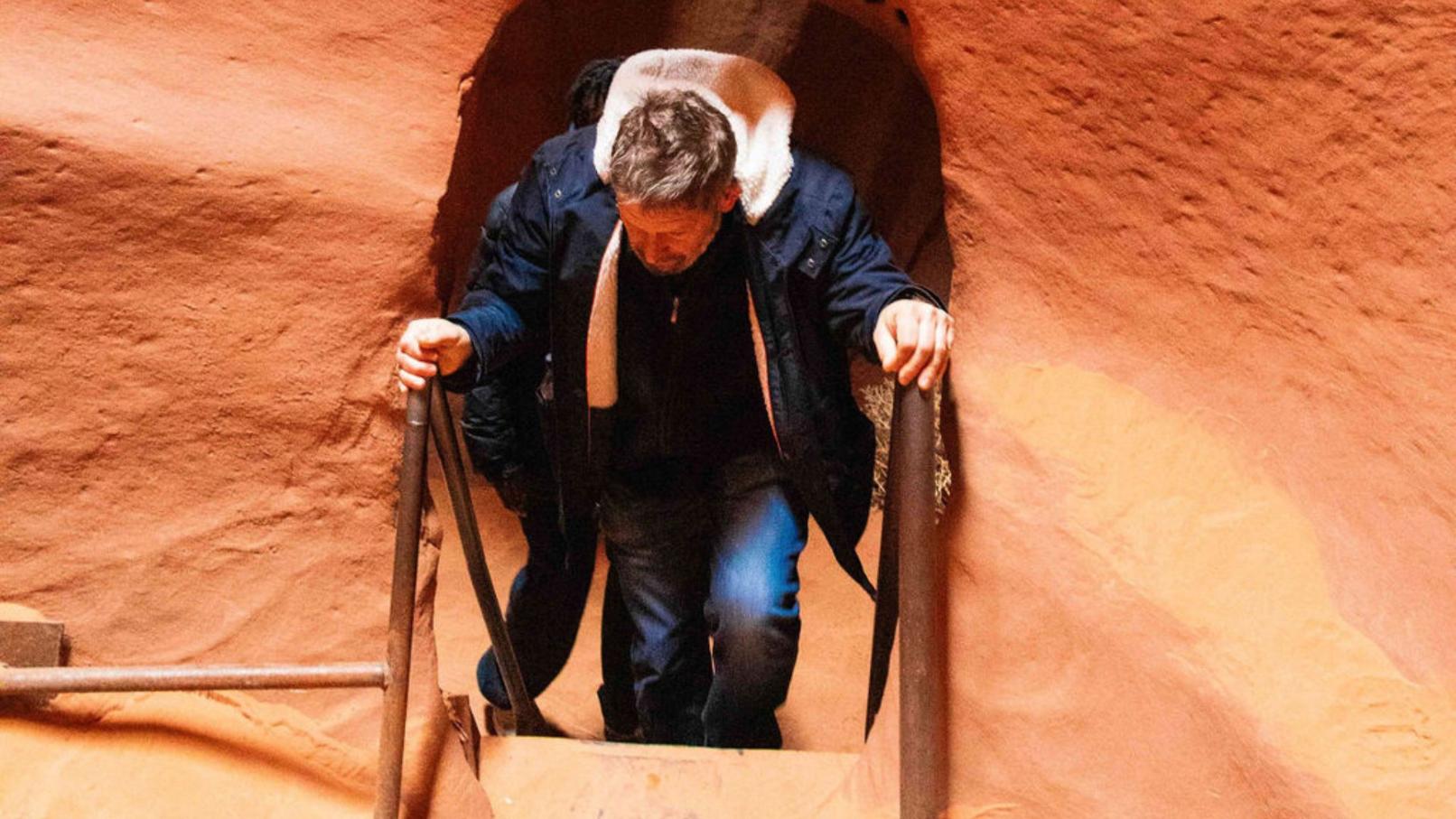 Man walking up stairs in Antelope Canyon