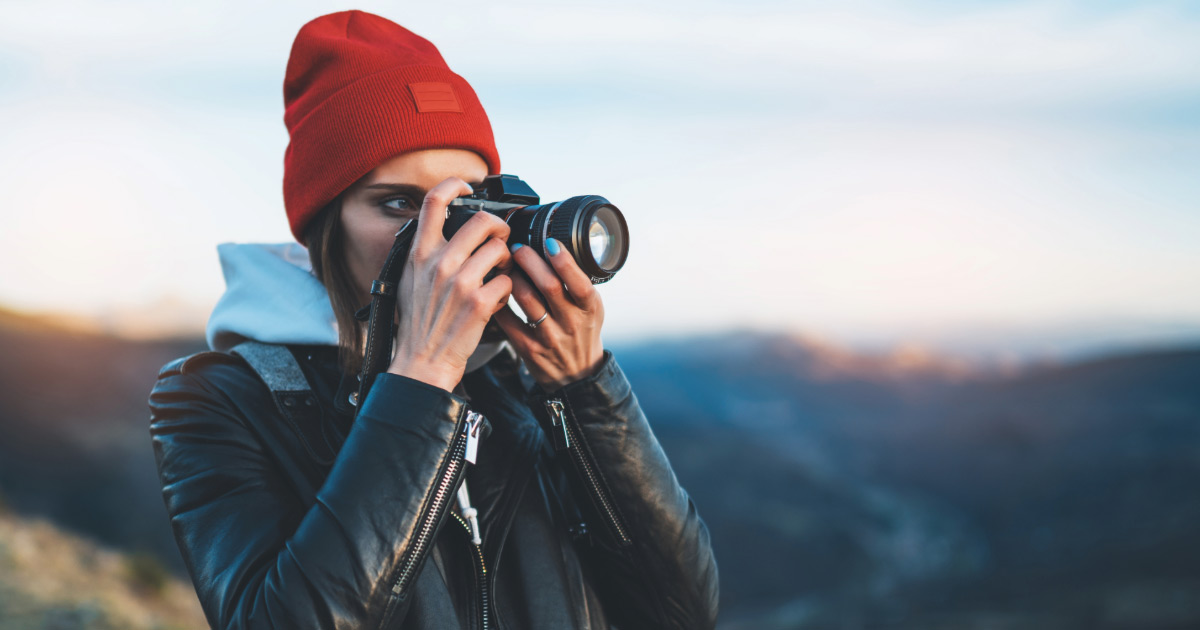 Woman taking photos outdoors with DSLR camera