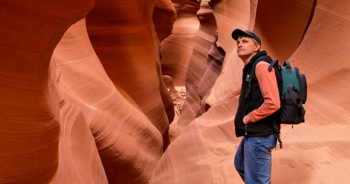 Man hiking through Lower Antelope Canyon