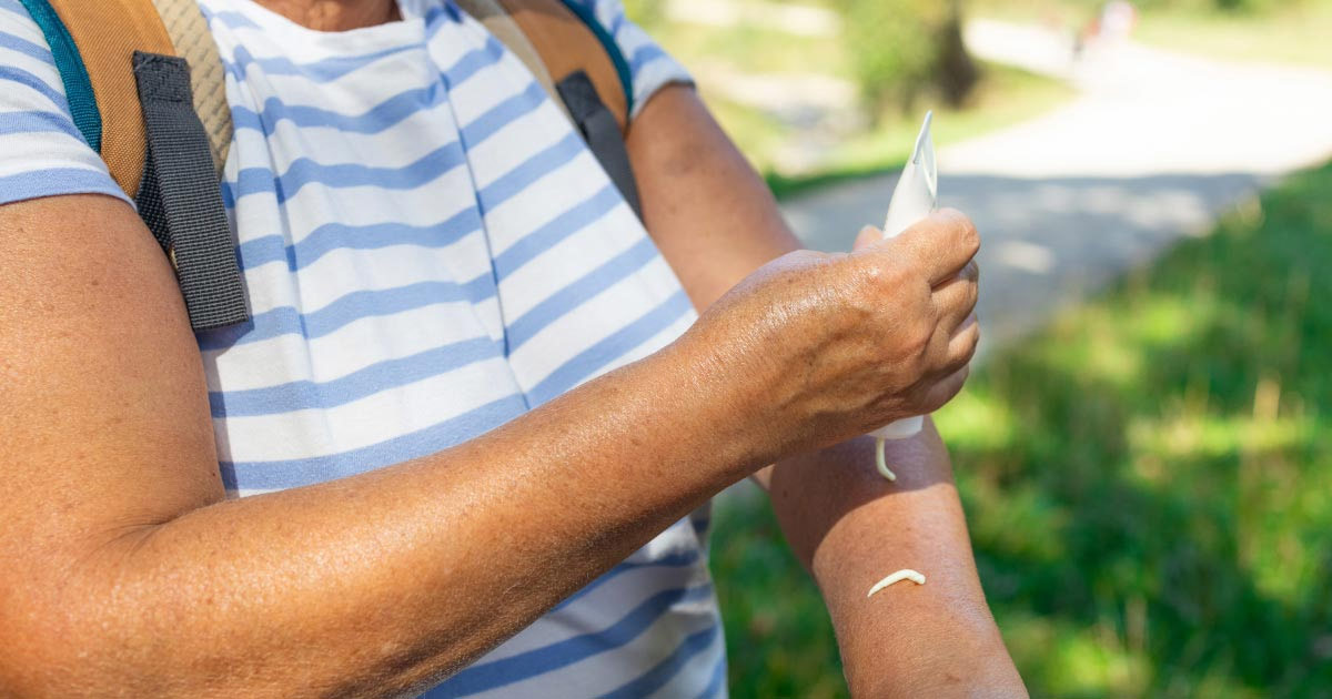 Woman applying sunscreen before going on an outdoor tour